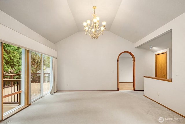 carpeted spare room featuring an inviting chandelier, baseboards, and vaulted ceiling