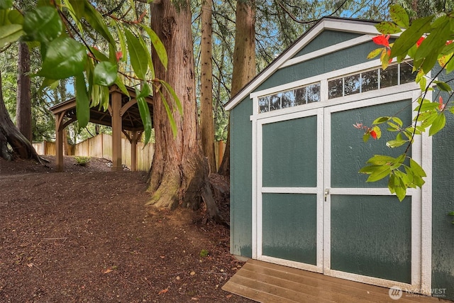 view of shed featuring fence
