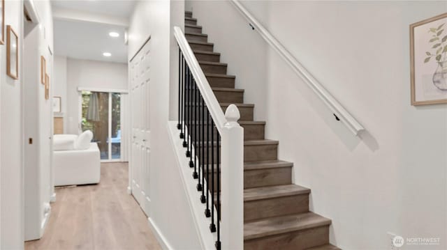 stairs with recessed lighting and wood finished floors