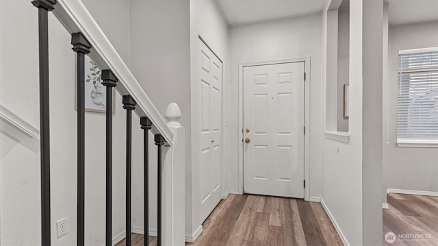 entryway featuring baseboards and wood finished floors