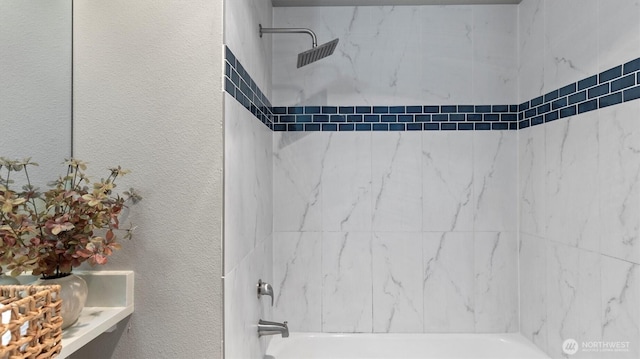full bathroom with a textured wall and washtub / shower combination