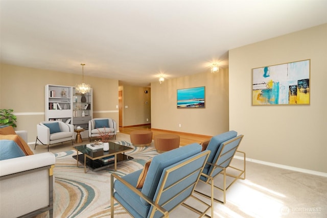living area featuring carpet flooring, baseboards, and an inviting chandelier
