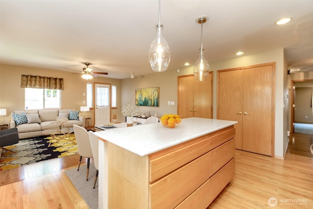 kitchen with recessed lighting, open floor plan, light brown cabinetry, and light wood-type flooring