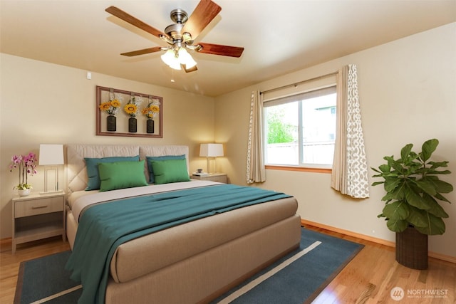 bedroom featuring baseboards, ceiling fan, and wood finished floors