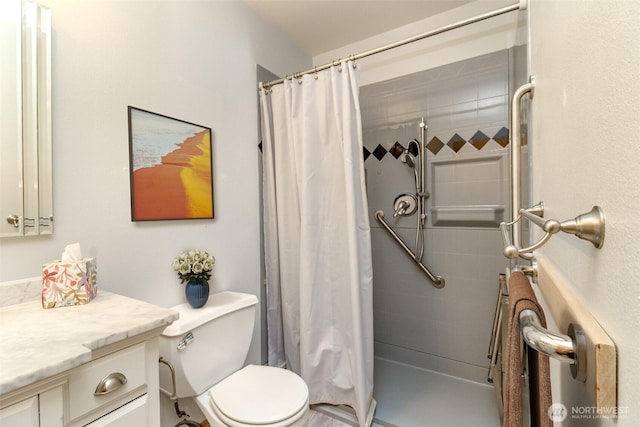 full bath with vanity, a tile shower, and toilet