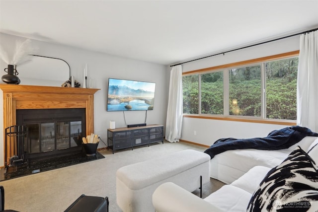 carpeted living room with plenty of natural light, a fireplace with flush hearth, and baseboards