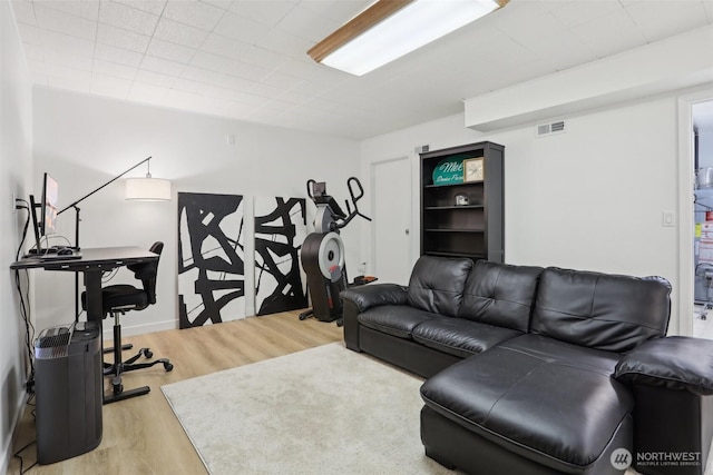 living room featuring visible vents and wood finished floors