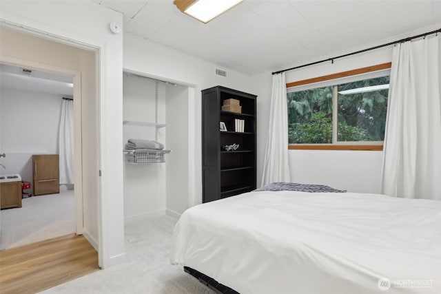 bedroom featuring a closet, visible vents, and carpet floors