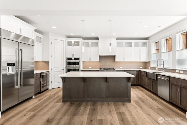 19512 81st Pl NE Unit 4, Kenmore, WA 98028 - kitchen with stainless steel appliances, wine cooler, a center island, light countertops, and recessed lighting