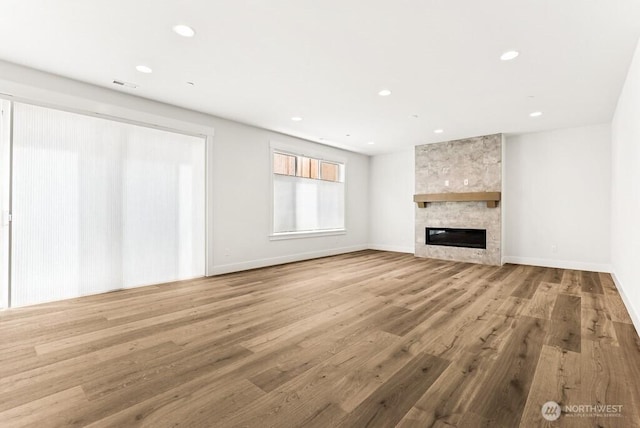 19512 81st Pl NE Unit 4, Kenmore, WA 98028 - unfurnished living room with a fireplace, recessed lighting, and wood finished floors