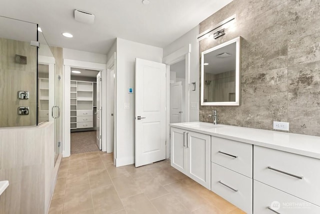 19512 81st Pl NE Unit 4, Kenmore, WA 98028 - full bath featuring a stall shower, tile patterned flooring, vanity, a walk in closet, and recessed lighting