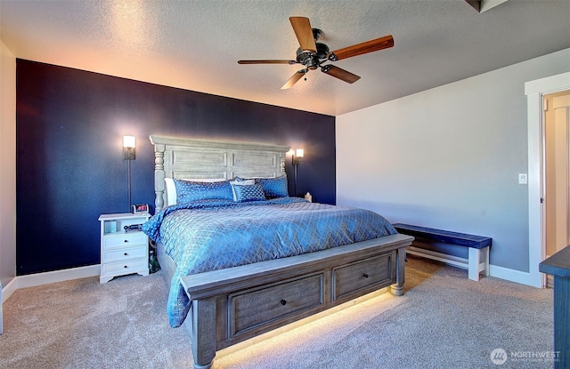 bedroom featuring carpet floors, baseboards, a ceiling fan, and a textured ceiling