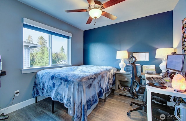 bedroom with baseboards, ceiling fan, and wood finished floors