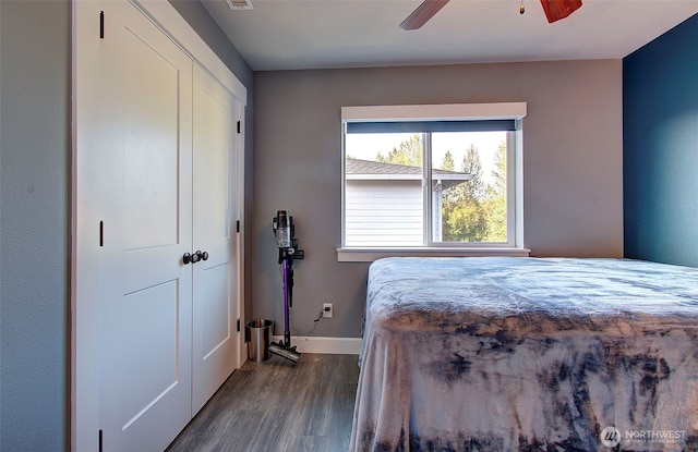bedroom featuring baseboards, ceiling fan, and dark wood-style flooring