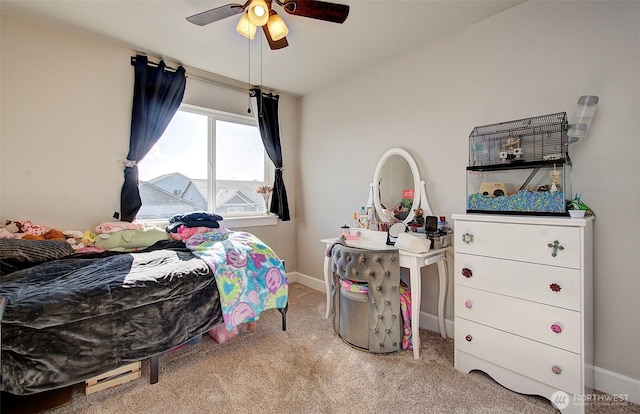 carpeted bedroom featuring baseboards and a ceiling fan
