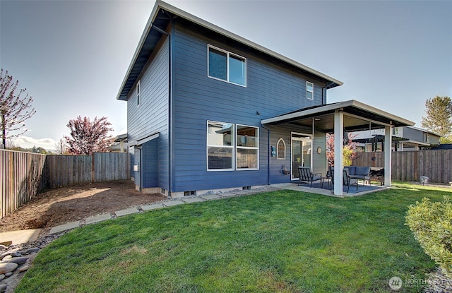 back of house with a lawn, a patio, and a fenced backyard