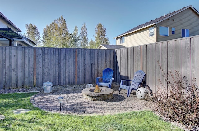 view of yard featuring fence and a fire pit