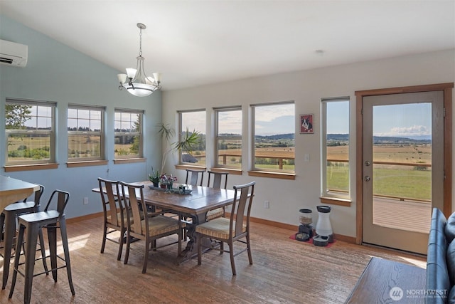 142 Pemberton Pl, Friday Harbor, WA 98250 - dining area with wood finished floors, a chandelier, an AC wall unit, and baseboards