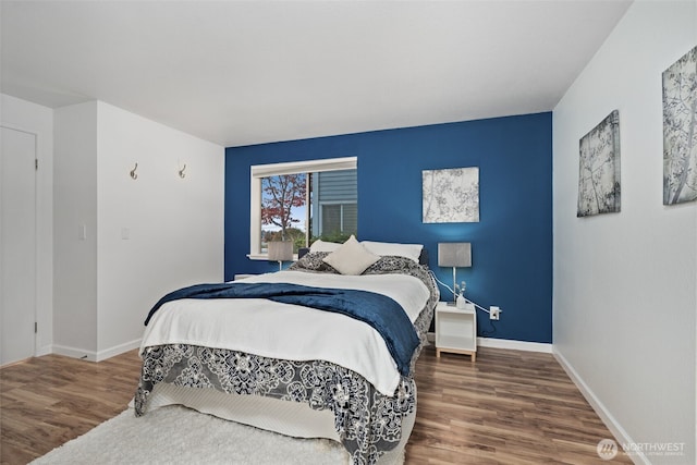 bedroom featuring wood finished floors and baseboards