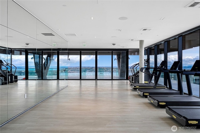 300 Virginia St Unit 1710, Seattle, WA 98101 - gym featuring light wood-style flooring, visible vents, a wall of windows, and plenty of natural light
