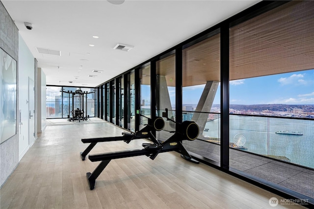 300 Virginia St Unit 1710, Seattle, WA 98101 - exercise room featuring wood finished floors, visible vents, and a wall of windows