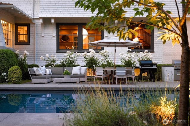 pool featuring an outdoor hangout area, a grill, and a patio