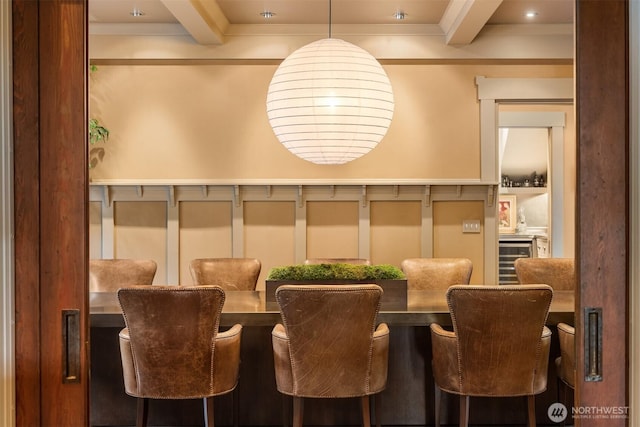 interior space with ornamental molding and beam ceiling