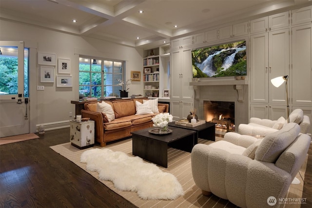living room with recessed lighting, dark wood finished floors, coffered ceiling, a warm lit fireplace, and beam ceiling