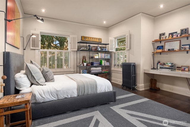 bedroom with radiator heating unit, wood finished floors, and recessed lighting