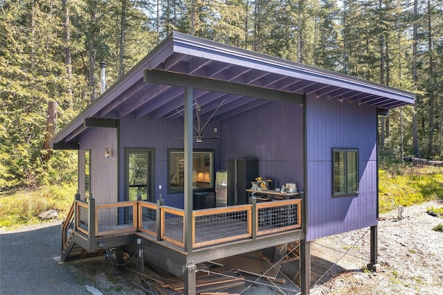 exterior space featuring a deck and a forest view