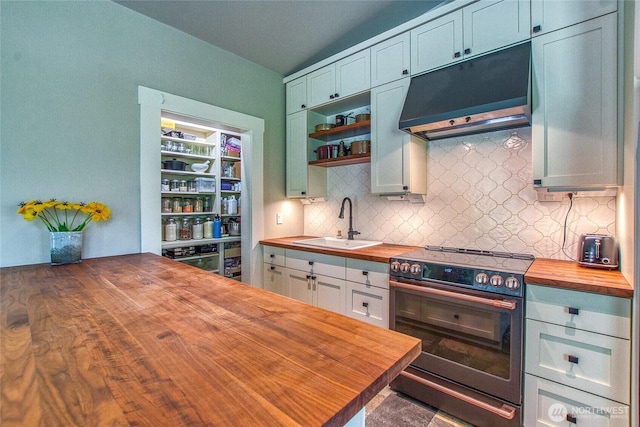 kitchen featuring range hood, a sink, butcher block countertops, backsplash, and stainless steel electric stove