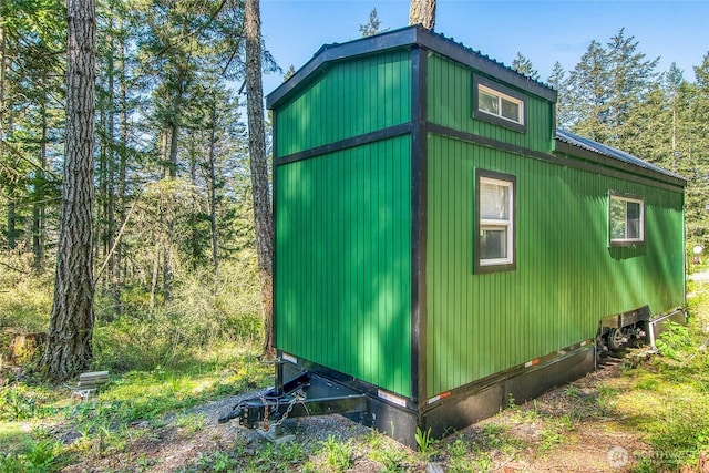 view of property exterior featuring entry steps and metal roof