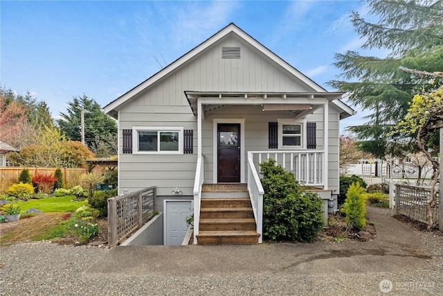 bungalow-style home with fence and a porch