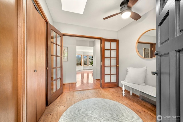 1016 Coronado Ave, Bellingham, WA 98229 - interior space with baseboards, light wood-type flooring, french doors, a ceiling fan, and a skylight