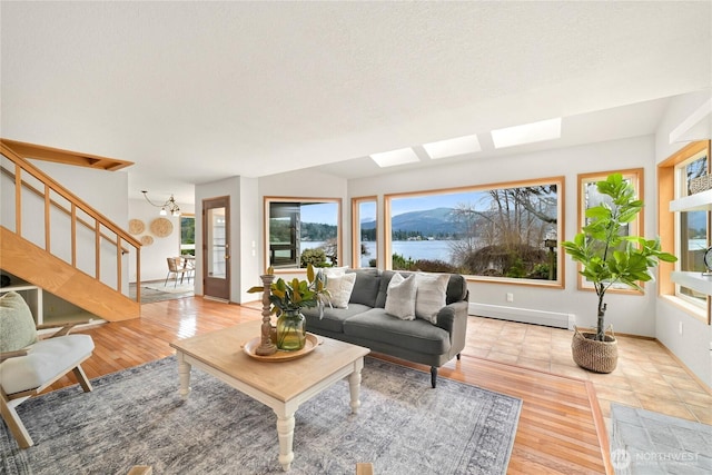 1016 Coronado Ave, Bellingham, WA 98229 - living room with a skylight, a baseboard heating unit, a water view, light wood finished floors, and stairway