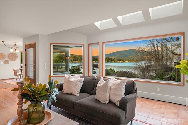 1016 Coronado Ave, Bellingham, WA 98229 - living area featuring baseboards, a skylight, and an inviting chandelier