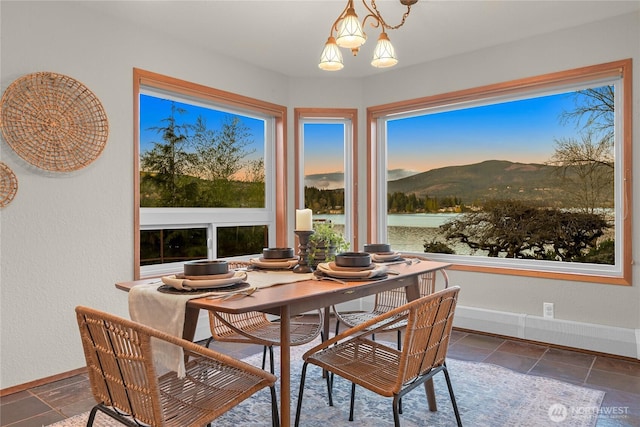 1016 Coronado Ave, Bellingham, WA 98229 - dining space featuring a mountain view, an inviting chandelier, stone tile floors, and baseboards