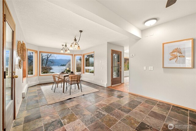 1016 Coronado Ave, Bellingham, WA 98229 - dining room with an inviting chandelier, stone tile flooring, and baseboards