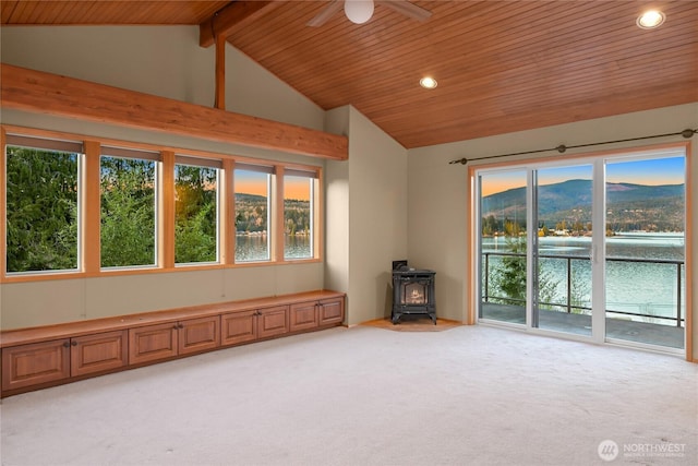 1016 Coronado Ave, Bellingham, WA 98229 - unfurnished room with wood ceiling, a wood stove, light carpet, a ceiling fan, and vaulted ceiling with beams