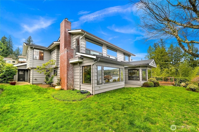 1016 Coronado Ave, Bellingham, WA 98229 - back of property with a lawn, a deck, a sunroom, and a chimney