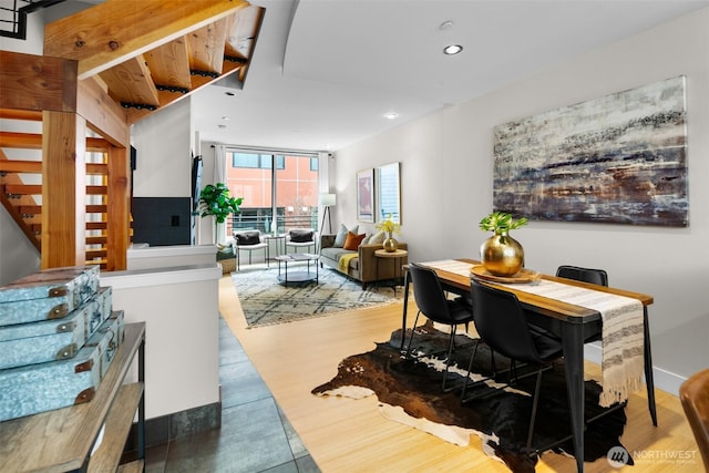dining area with wood finished floors, baseboards, and recessed lighting