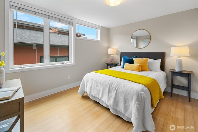 bedroom featuring baseboards and wood finished floors