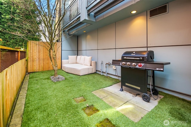view of yard featuring fence and visible vents