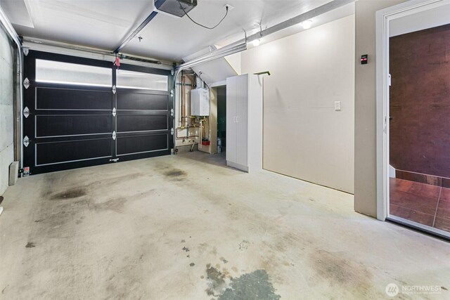 garage with tankless water heater and a garage door opener