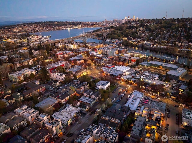 birds eye view of property featuring a water view and a city view