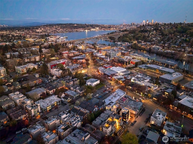 birds eye view of property with a water view and a view of city