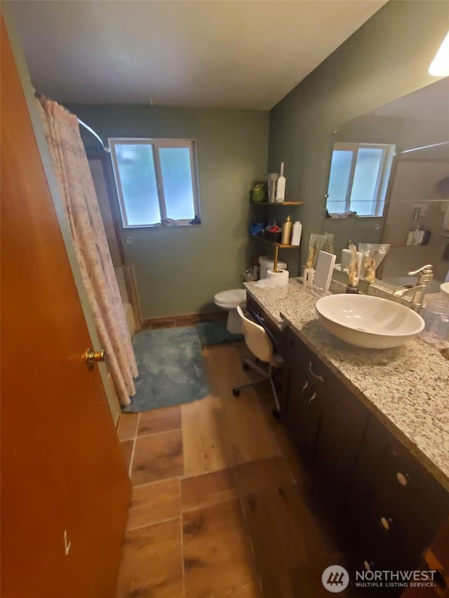 4709 SE 26th Ave, Lacey, WA 98503 - full bathroom featuring toilet, wood finished floors, vanity, and shower / bath combo