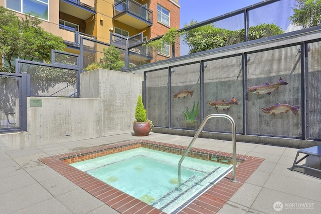 view of swimming pool featuring an in ground hot tub