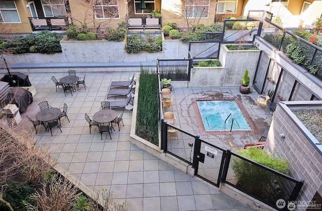 view of swimming pool with fence and a patio