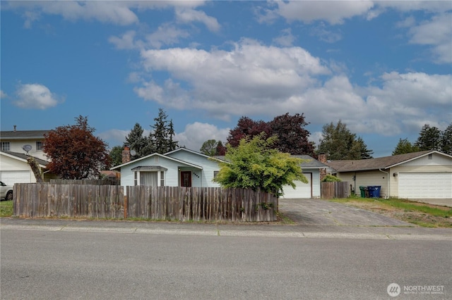 view of front of property with a detached garage and a chimney